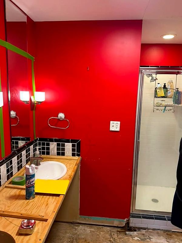 Before: bathroom with red walls and a framed shower stall