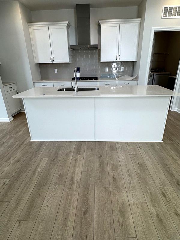 Before: white kitchen with a plain gray subway backsplash